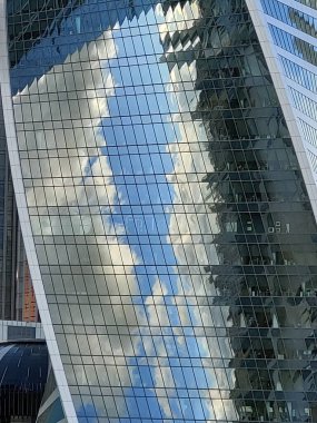 Part of a new buildings made of glass and concrete, modern architecture, details, windows, reflections