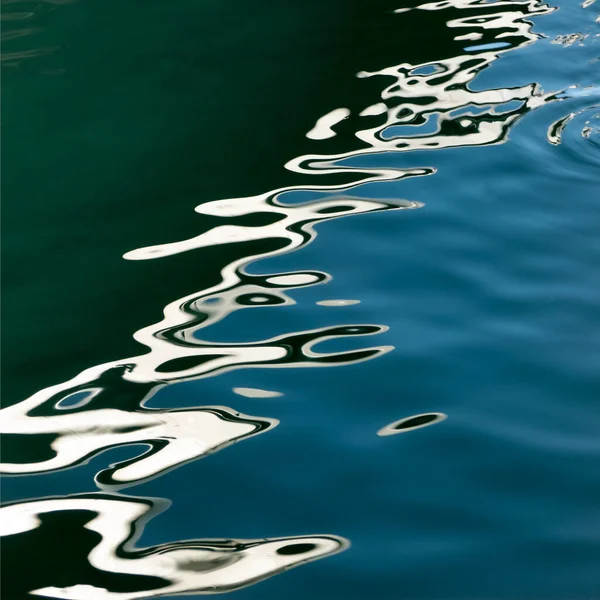 Abstract background. Drawing on the water. Reflection in the waves.