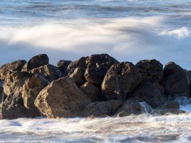 Crashing waves on the beach in massa clipart