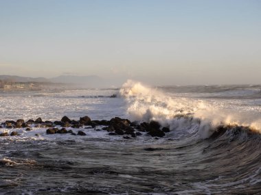 Crashing waves on the beach in massa clipart