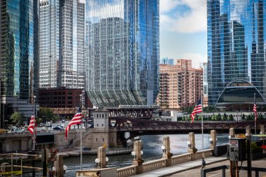 Chicago, Illinois, United States of America : October 11, 2018, Train on elevated tracks within buildings at the Loop, Glass and Steel bridge between buildings - Chicago City Center - Chicago, Illinois, USA clipart