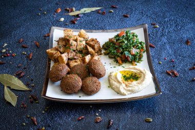 Famous falafel houmous and orienal mixed plate clipart