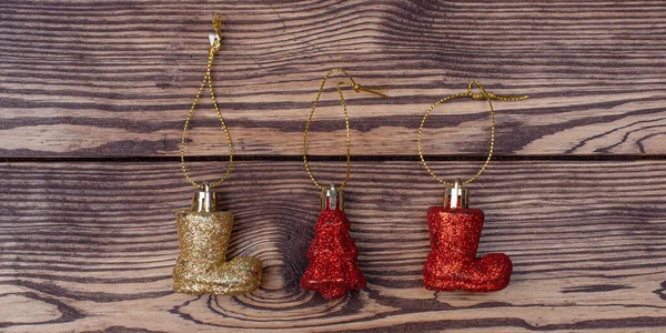 Boot and tree Christmas toys on wooden background