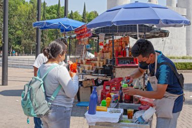 MEXICO CITY, MEXICO. March 24, 2022: Treats stand iwith batanas, chips, maxican snachs n Chapultepec park, Mexico City, Mexico,