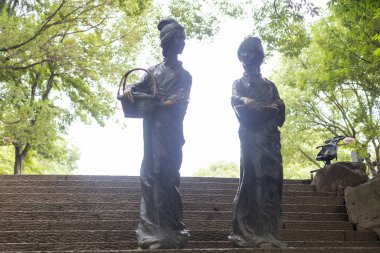 Zhuji, Zhejiang, Çin - 18 Haziran 2023: Xi Shi 'nin şehir parkının manzarası ve Zhuji, Zhejiang Eyaleti, Çin' deki nehir kıyısındaki kadın heykelleri