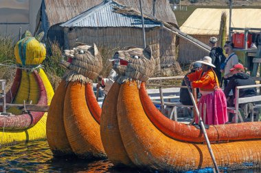 Uros, Peru - April 29, 2022: Tourist boats made of reed moored at Uros Islands, Lake Titicaca, Peru clipart