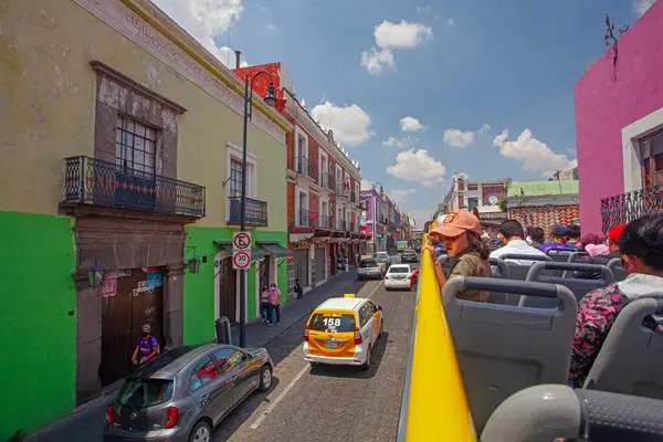 stock image Puebla, Mexico - March 19, 2022: The tourist shuttle bus witth people on the city downtown streets 