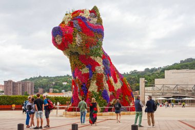 Bilbao, İspanya - 15 Temmuz 2024: Bilbao 'nun Guggenheim Müzesi' nin önünde duran çiçekli çalı ağacı İspanya 'nın beşinci büyük kentinin sembolüdür..