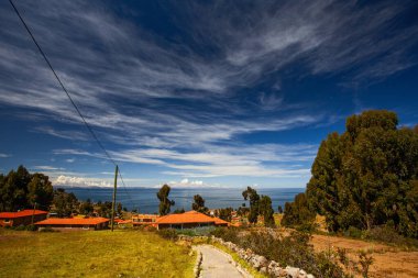 Houses of Local Peruvian People Living on Taquile Island (Isla Taquile) at Lake Titicaca in Puno Peru. clipart