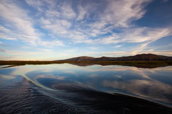 stock image Beautiful titicaca lake and Andes mountains at sunset time , taken from the ship  during the tour from  Puno, Peru