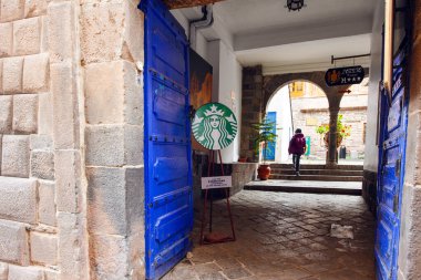 Cuzco, Peru - April 30, 2022:  Famous Starbucks cafe in ancient Cuzco downtown with stone streets,   Peru clipart