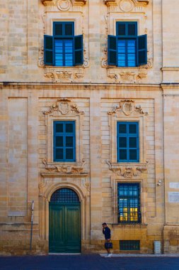 Valletta, Malta - February 13, 2024:  Valletta old town with Maltese colorful balconies, shops and  touristic restaurants taken in the center  clipart