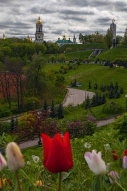 Kyiv city view flom park Slavy ( immortal glory) with tulips flowerbe clipart