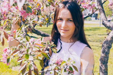 Kyiv 'deki Sakura bahçe parkında beyaz elbiseli güzel bir kadın.