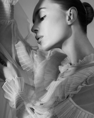 young beautiful girl posing in a romantic dress. Sunlight. Sexy model in transparent dress.