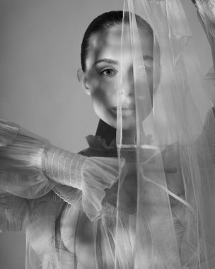 young beautiful girl posing in a romantic dress. Sunlight. Sexy model in transparent dress.