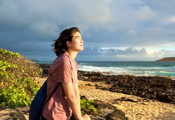 Young Woman Sitting Rocky Beach Watching Sun Rise Hawaiian Ocean Imágenes De Stock Sin Royalties Gratis