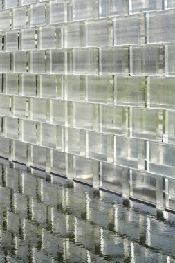 Glass brick wall with reflection in water