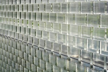 Glass brick wall with reflection in water