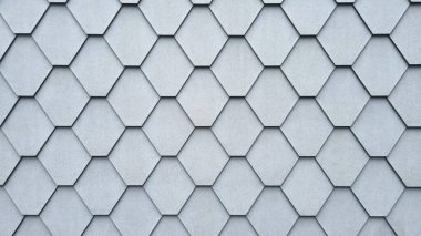 Altıgen fayanslardan yapılmış gri bir binanın ön cephesi.