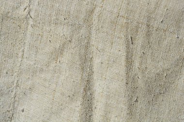 Close-up detail of coarse-woven beige linen fabric clipart