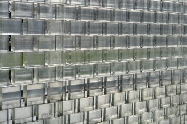 Glass brick wall with reflection in water