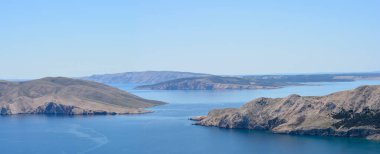 A high-angle view of the sea passage between the islands of Prvic (left) and Krk, with the islands of Sveti Grgur and Rab in the distance clipart