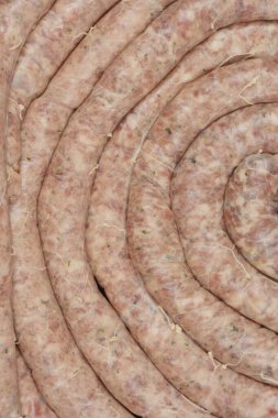 Kapalı, tepeden tırnağa sarılmış çiğ sosislerin görüntüsü, dokularını ve hazırlıklarını vurguluyor.