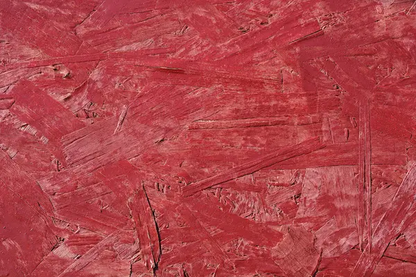 Yakın plan, kırmızı boyalı bir iplik yüzeyini gösterir.