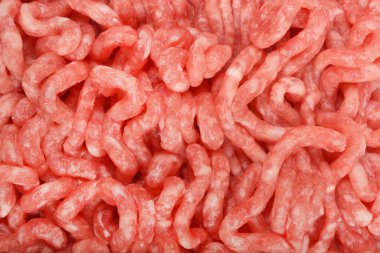 Detaylı yakın çekim ham, açık pembe et dokusunu yakalar, kendi ipliklerini ve ince mermerlerini gösterir.