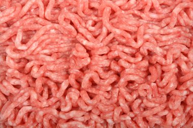 Detaylı yakın çekim ham, açık pembe et dokusunu yakalar, kendi ipliklerini ve ince mermerlerini gösterir.