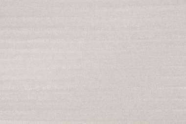 Yatay çizgili açık gri bir EPE köpük kağıdının dokusuna yakın çekim