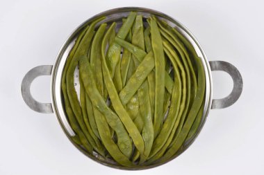 Buharda pişmiş yeşil fasulyeler, metal bir buhar tenceresinde, servis edilmeye hazır bir şekilde güzelce düzenlenir.