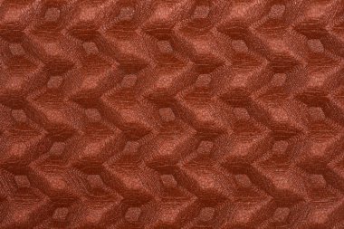 Tekrarlayan altıgen ya da elmas şekilli kahverengi desenli bir yüzeye yakın çekim