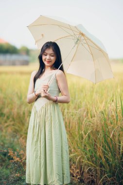 Relaxed brunette girl walking on rice fields