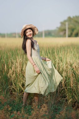 Relaxed brunette girl walking on rice fields