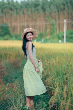 Relaxed brunette girl walking on rice fields