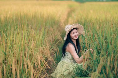Relaxed brunette girl walking on rice fields