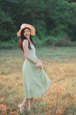 Relaxed brunette girl walking on rice fields