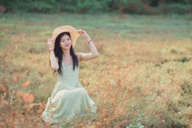 Relaxed brunette girl walking on rice fields