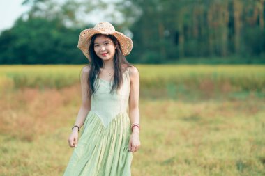 Relaxed brunette girl walking on rice fields