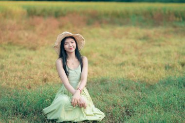 Relaxed brunette girl walking on rice fields