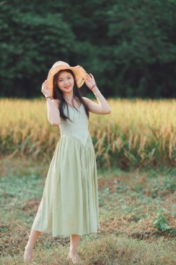 Relaxed brunette girl walking on rice fields