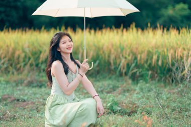 Relaxed brunette girl walking on rice fields
