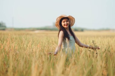 Relaxed brunette girl walking on rice fields