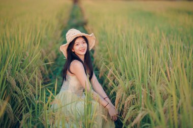 Relaxed brunette girl walking on rice fields