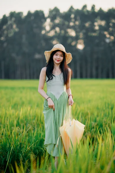 Relaxed brunette girl walking on rice fields