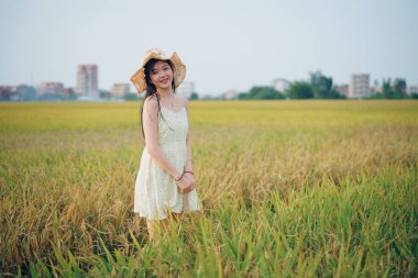 Relaxed brunette girl walking on rice fields