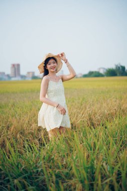 Relaxed brunette girl walking on rice fields