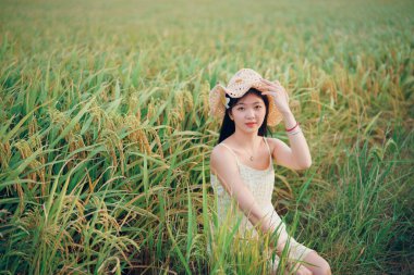 Relaxed brunette girl walking on rice fields